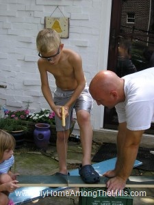 Hand sawing the board