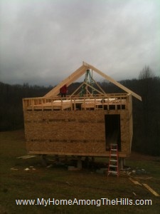 A bunch of rafters in place on our small cabin