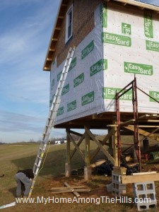 Putting housewrap on our small cabin