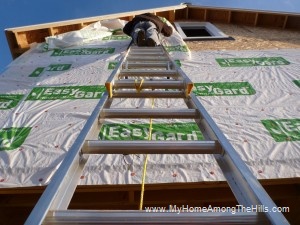 Putting housewrap on our small cabin