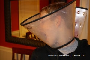 The boy wearing an Elizabethan collar